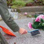 Cleaning- hand sweeping headstone with pink flowers