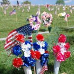 Patriotic flower arrangement and flags at markers