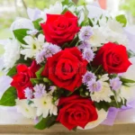 Red roses and white daisies and purple flowers