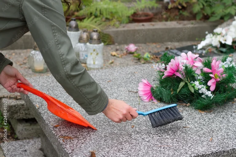 Cleaning-hand-sweeping-headstone-with-pink-flowers